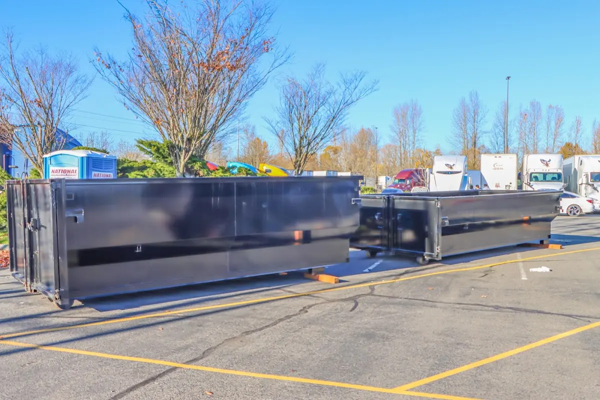 Professional dumpster rental service with roll-off container on residential driveway in Fresno